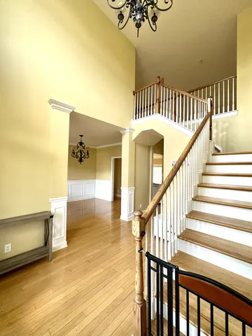 a view of entryway and hall with wooden floor