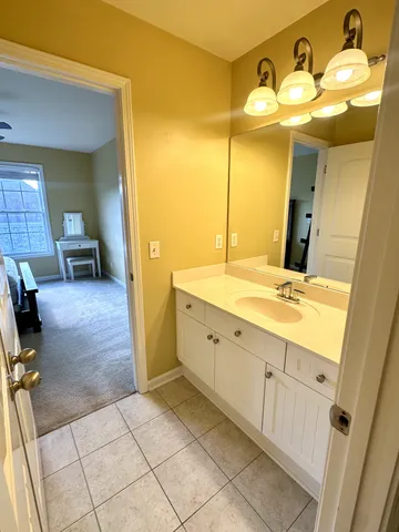 a spacious bathroom with a double vanity sink mirror and bathtub