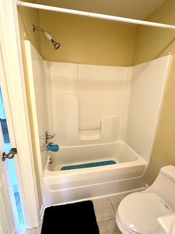 a living room with a bed and a window