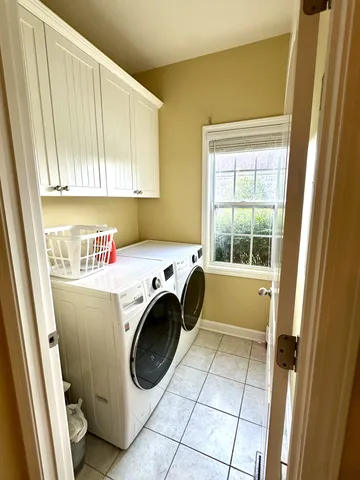 a bathroom with a granite countertop sink and a toilet