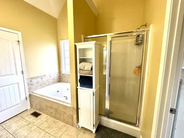 a bedroom with bed and a window