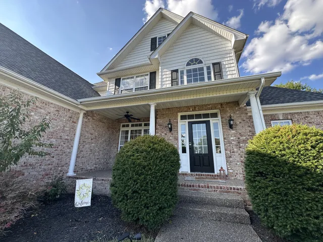 front view of a house with a potted plant