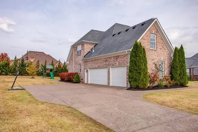 a view of a house with basket ball court and a garage