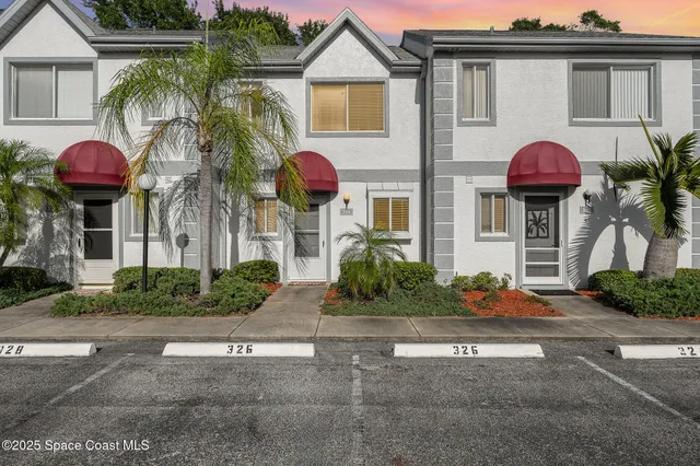 a front view of house with yard and outdoor seating