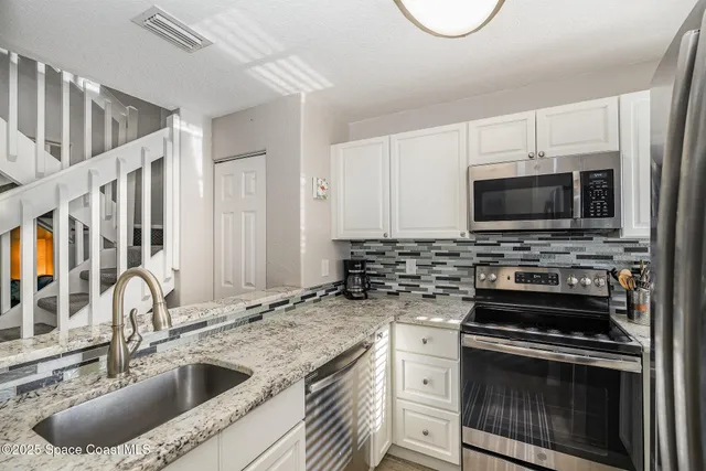 a kitchen with a sink stove and microwave