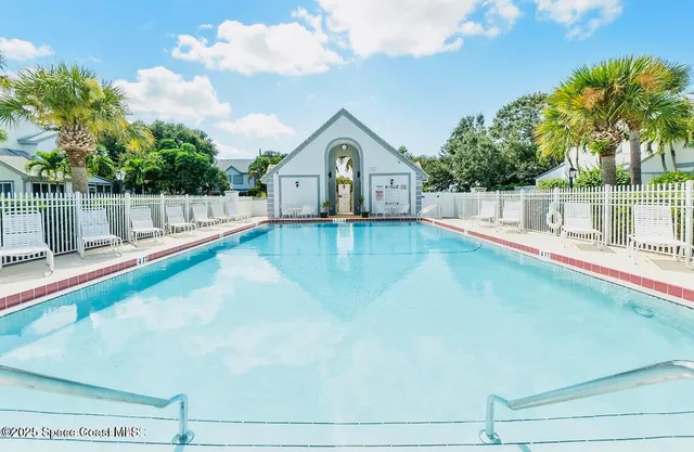 a view of a tennis ground with large trees