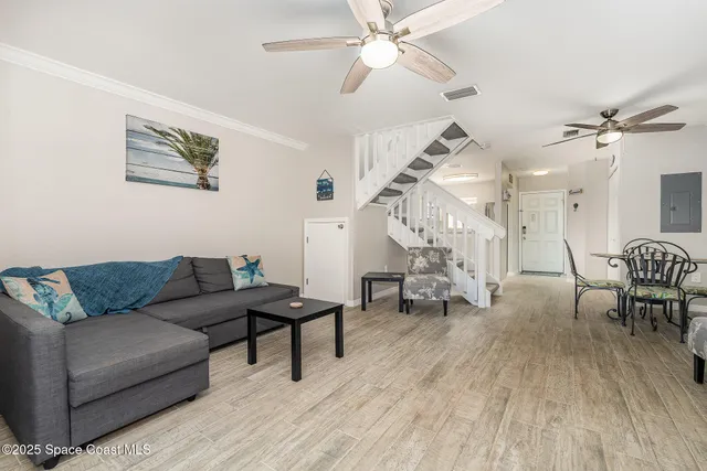a living room with furniture and wooden floor