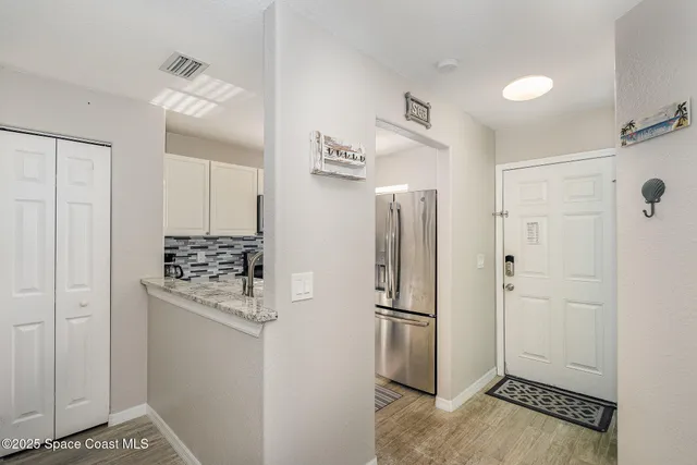 a kitchen with stainless steel appliances a refrigerator and cabinets