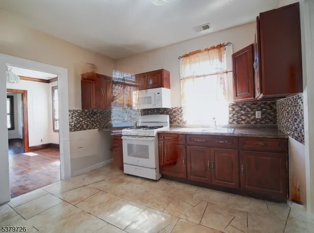 a kitchen with a sink stove and cabinets