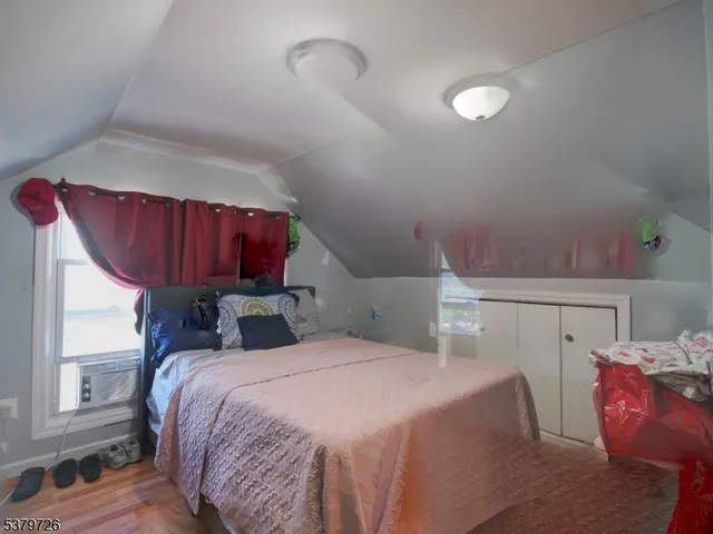a bed sitting in a bedroom next to a window