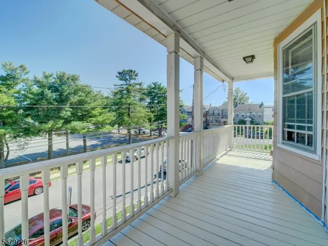 a view of a balcony with wooden floor