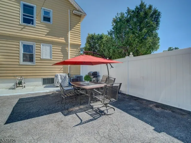 a patio with a table and chairs