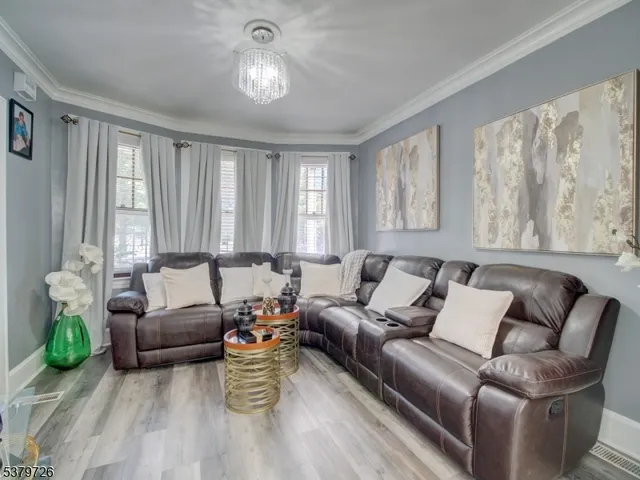 a living room with furniture and a chandelier