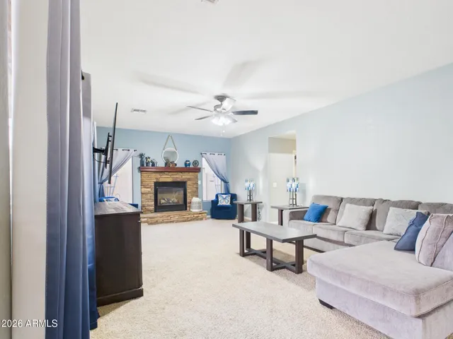 a kitchen with stainless steel appliances granite countertop a stove top oven a refrigerator a sink and a dining table with wooden floor