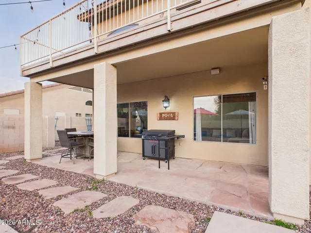 a view of a street with a yard and large trees