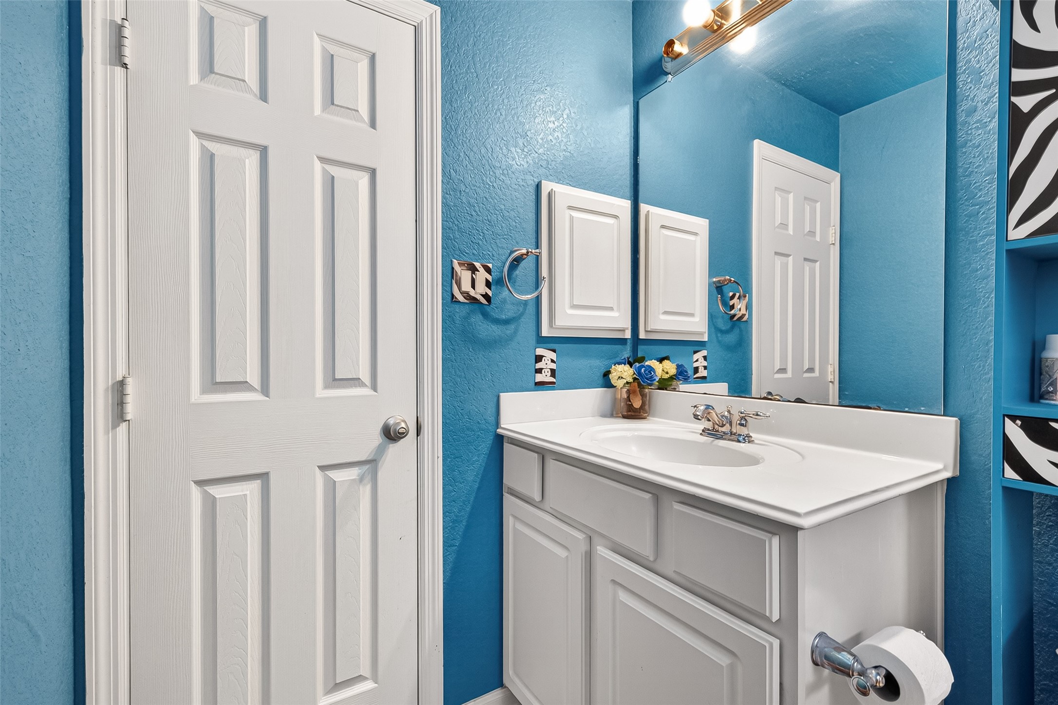 16715 Mackenzie Mesa Drive Spring, TX 77379 - Photo 25 of 50 a bathroom with a sink vanity and a mirror