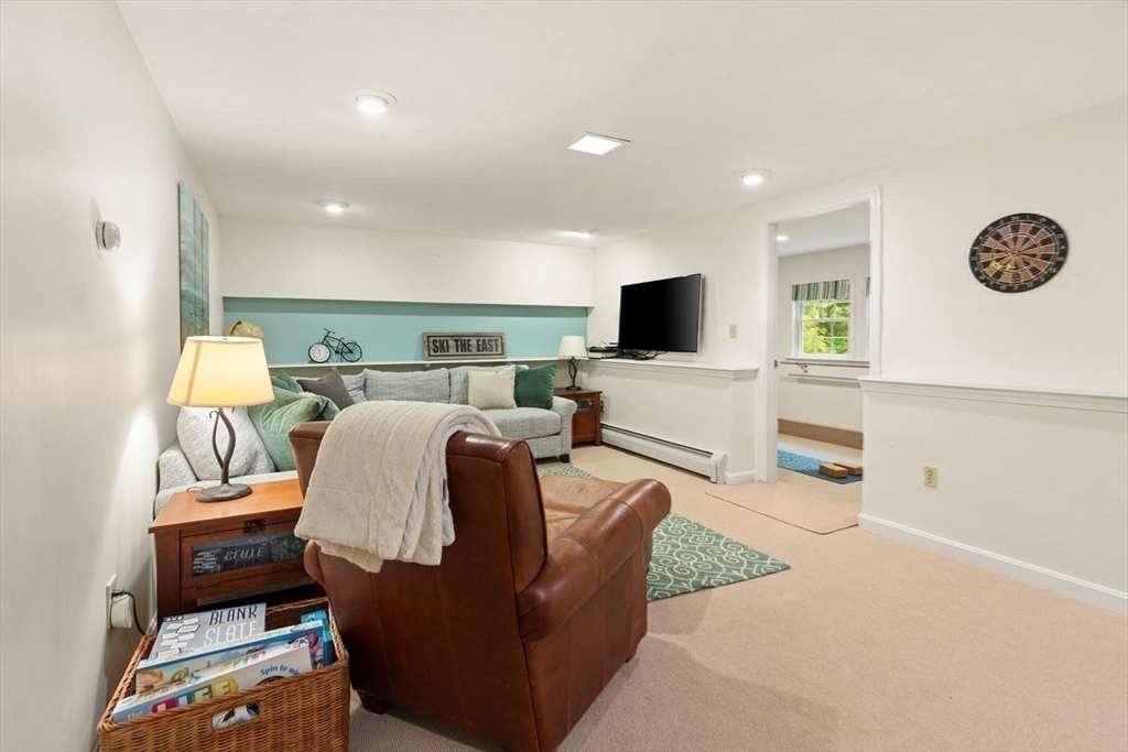105 Thornberry Road Winchester, MA 01890 - Photo 25 of 35 a living room with furniture a flat screen tv and a table