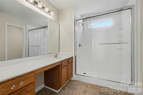 a bathroom with a double vanity sink and mirror