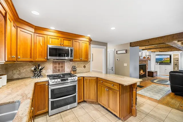 a kitchen with stainless steel appliances granite countertop a stove and a sink