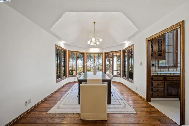 a large room with wooden floor and windows