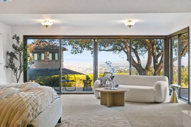 a living room with a couch and a floor to ceiling window