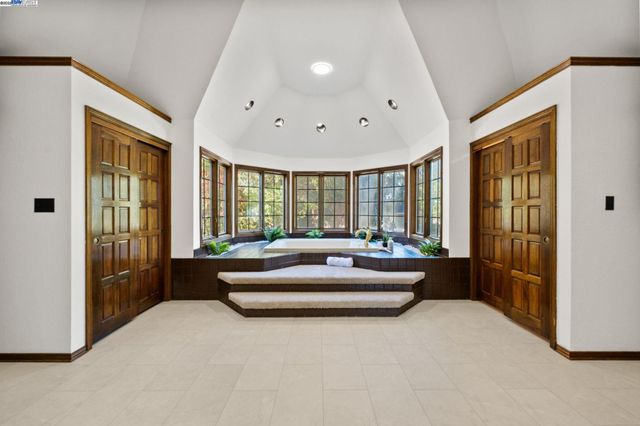 a spacious bedroom with a large bed and a large window