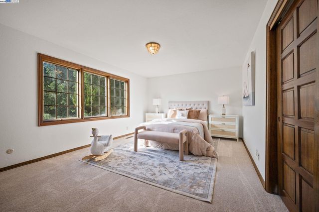 a bedroom with furniture and a window