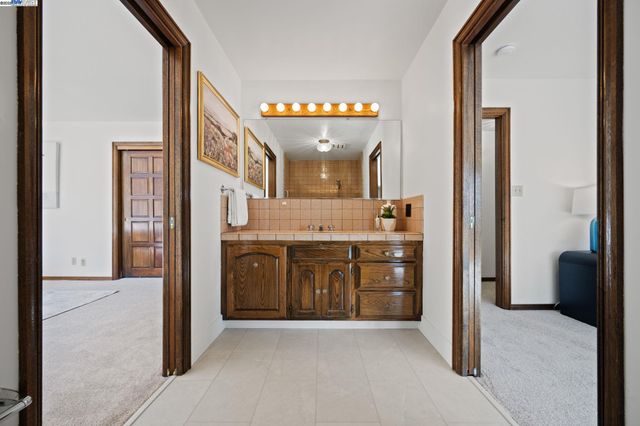 a bathroom with a sink a mirror and a shower