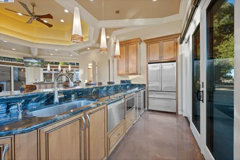 a large white kitchen with a large window