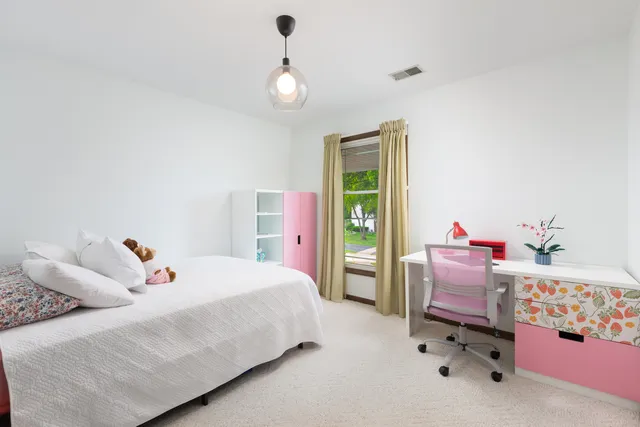a spacious bathroom with a double vanity sink and a mirror