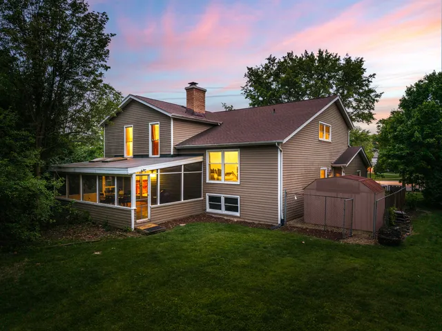 a view of a yard in front of a house with large trees