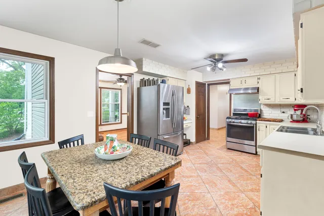 a dining room with furniture and window