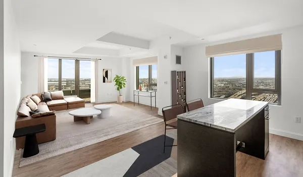 a living room with furniture and large windows