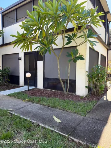 a front view of a house with a yard and a garage