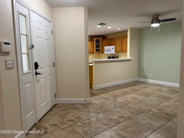 a view of a kitchen with a sink and cabinets
