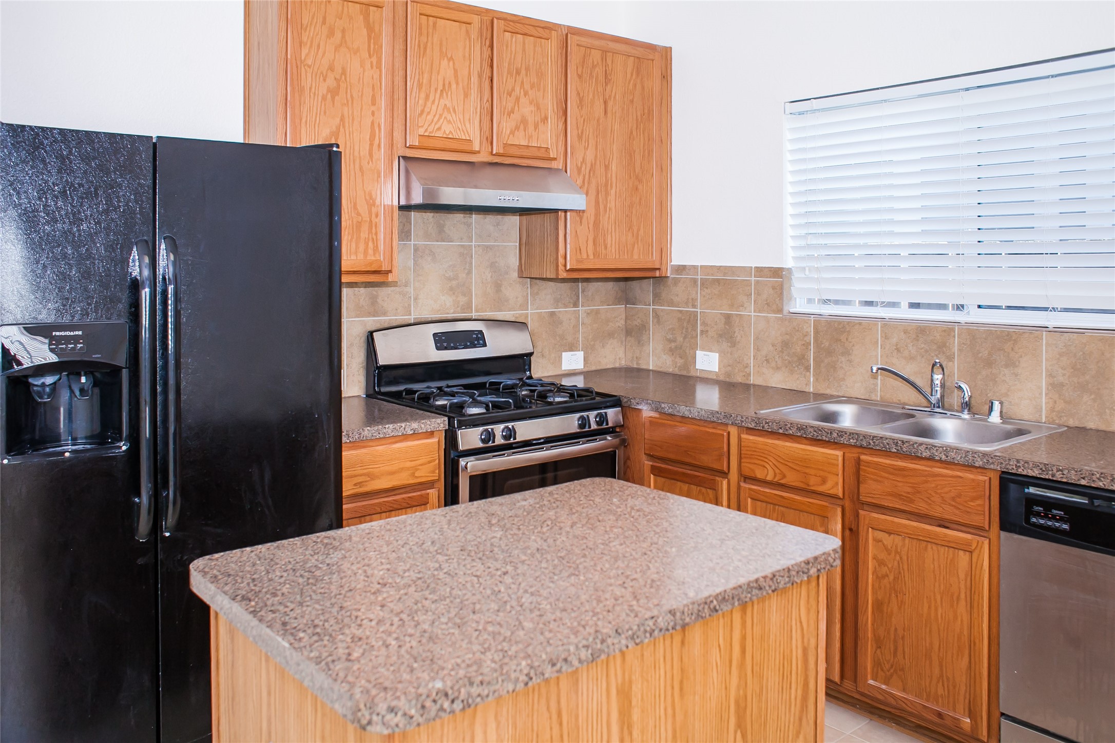 7015 Rancho Mission Drive Houston, TX 77083 - Photo 11 of 21 a kitchen with granite countertop a refrigerator stove and sink