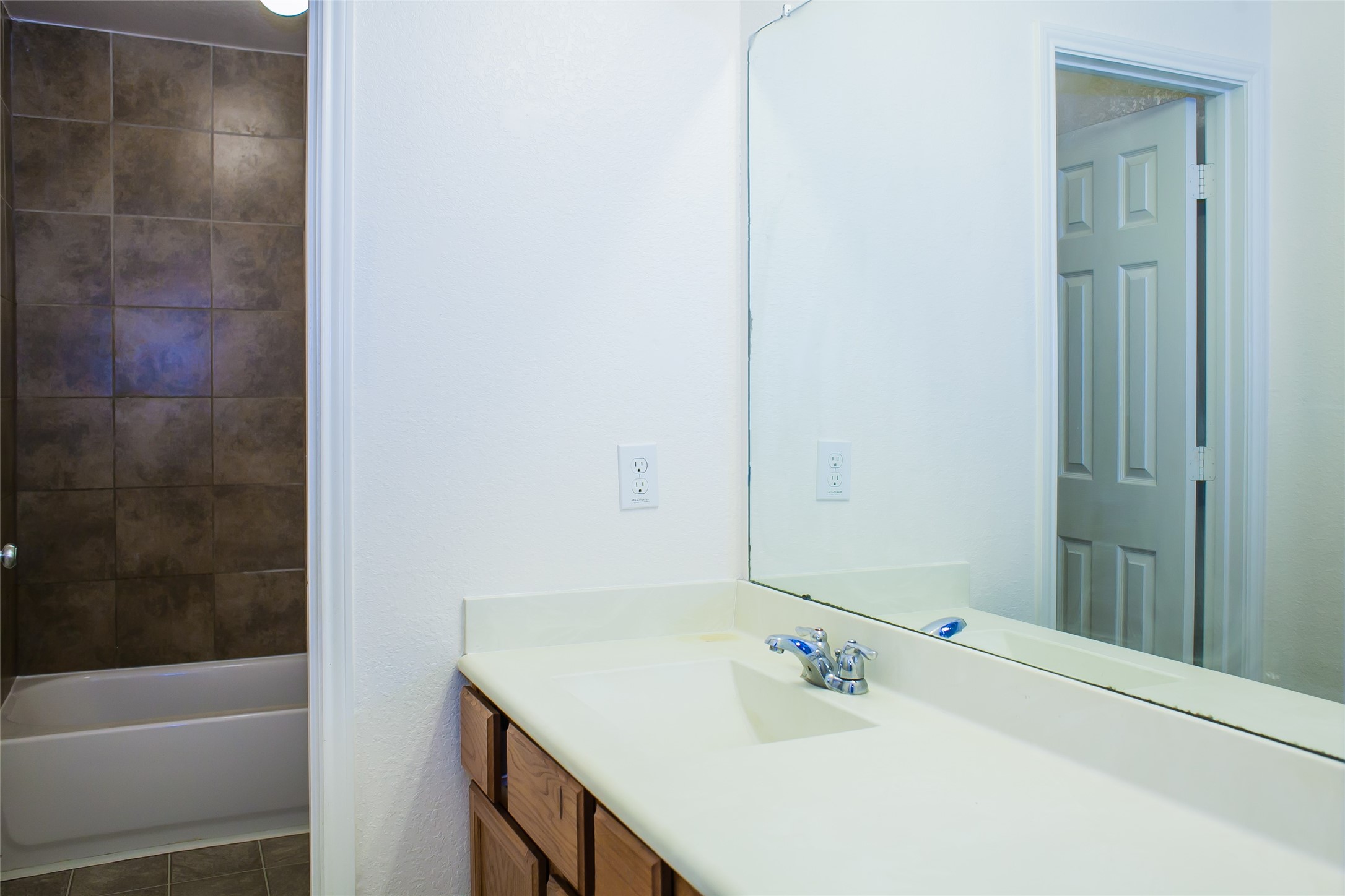 7015 Rancho Mission Drive Houston, TX 77083 - Photo 18 of 21 a bathroom with a sink and a mirror