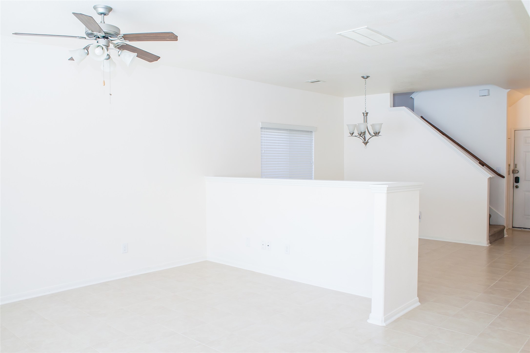 7015 Rancho Mission Drive Houston, TX 77083 - Photo 2 of 21 a view of a room with a ceiling fan and a window