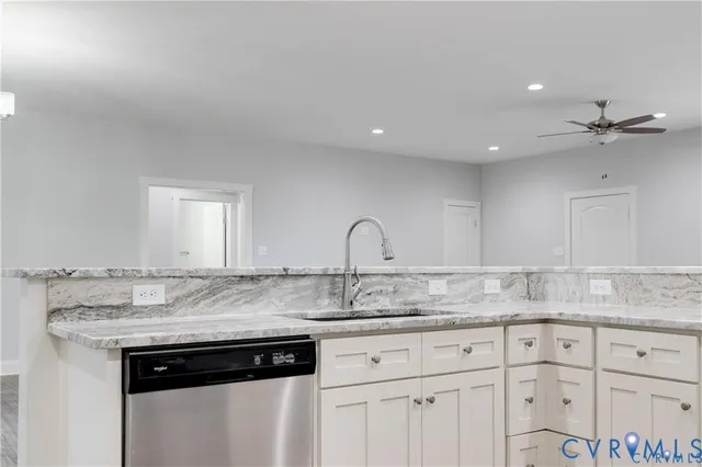 a large kitchen with stainless steel appliances granite countertop a stove top oven a sink and dishwasher