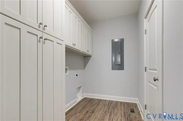a kitchen with granite countertop a sink stainless steel appliances and white cabinets