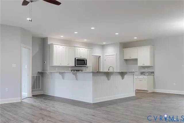 a large kitchen with a large window and stainless steel appliances