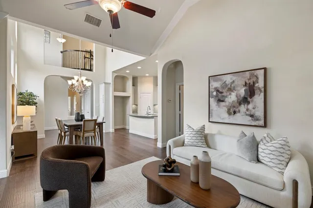 a living room with furniture and a chandelier