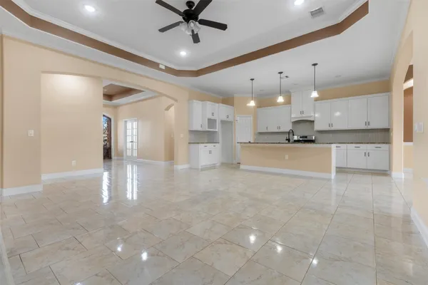 a view of a kitchen with a stove and a chandelier