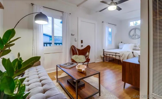 a living room with furniture and a chandelier