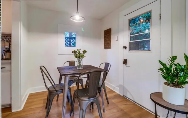 a view of a dining room with furniture window and wooden floor