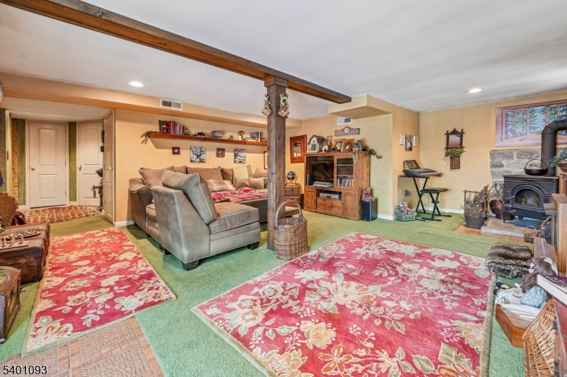 54 Hillside Road Sparta, NJ 07871 - Photo 20 of 45 a bed room with furniture and a flat screen tv
