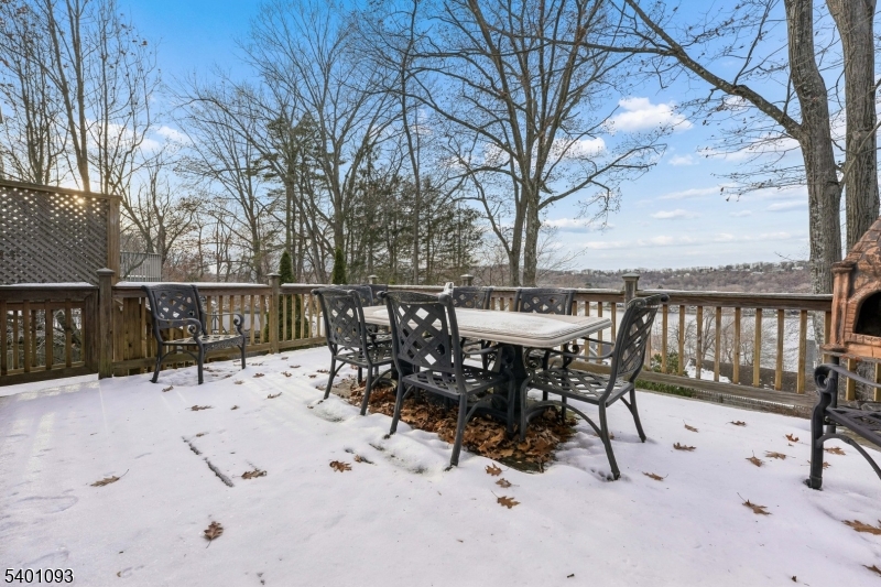 54 Hillside Road Sparta, NJ 07871 - Photo 25 of 45 a view of a roof deck with table and chairs and wooden fence