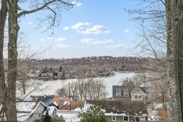 a view of a balcony with wooden floor and fence