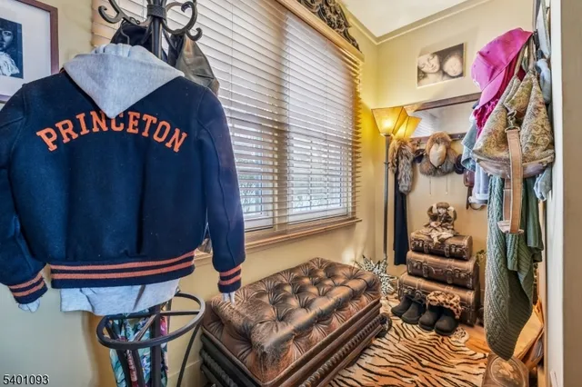 a view of a patio with table and chairs potted plants and floor to ceiling window
