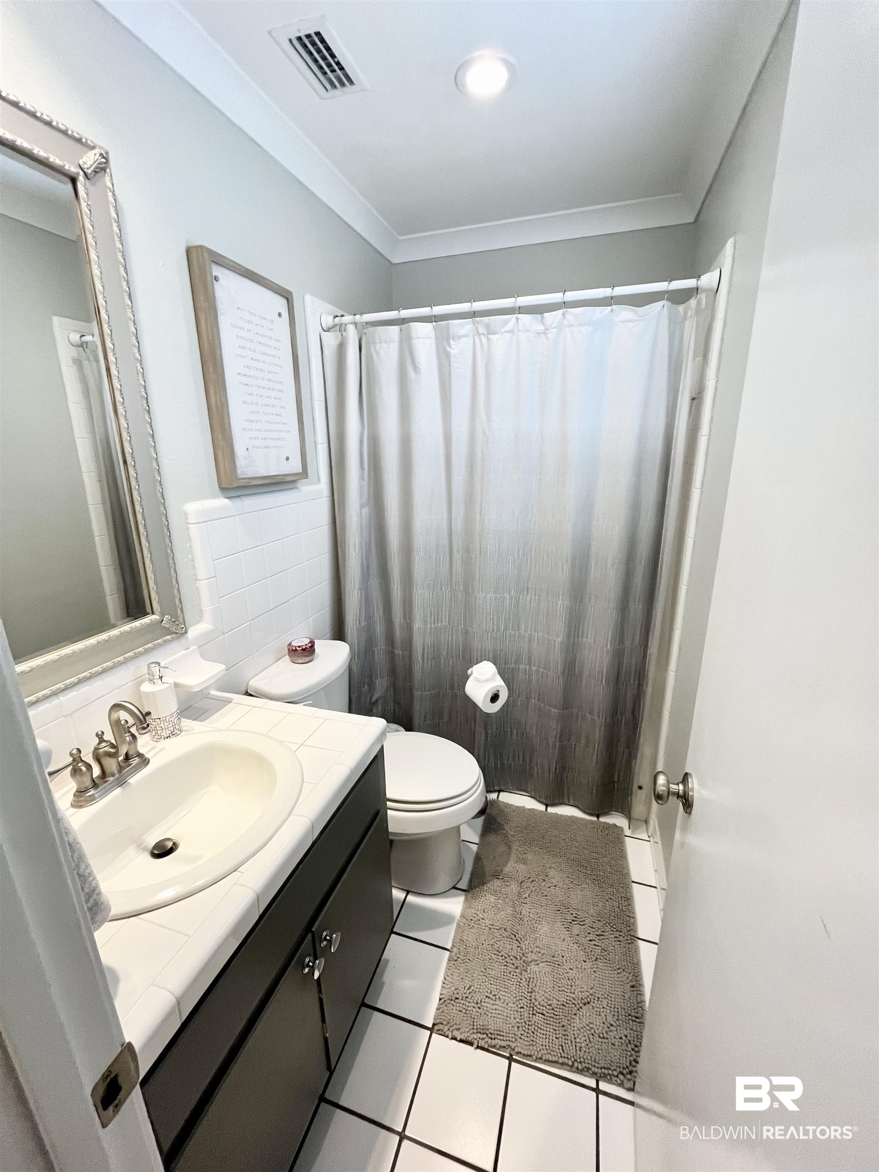 451 Ridgelawn Drive West Mobile, AL 36608 - Photo 29 of 41 Full bath with toilet, tile patterned flooring, vanity, tile walls, and crown molding